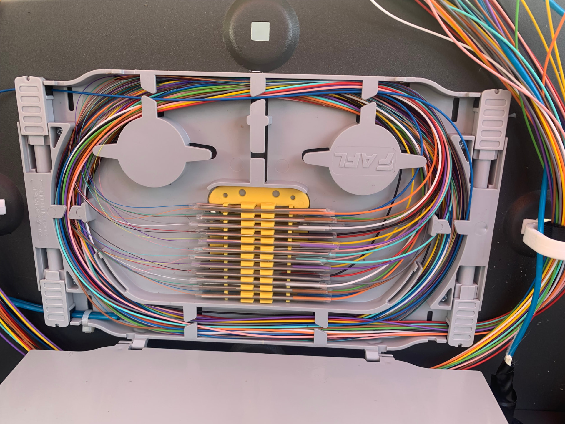 Fibre optic splicing in a comms cabinet during NBN delivery